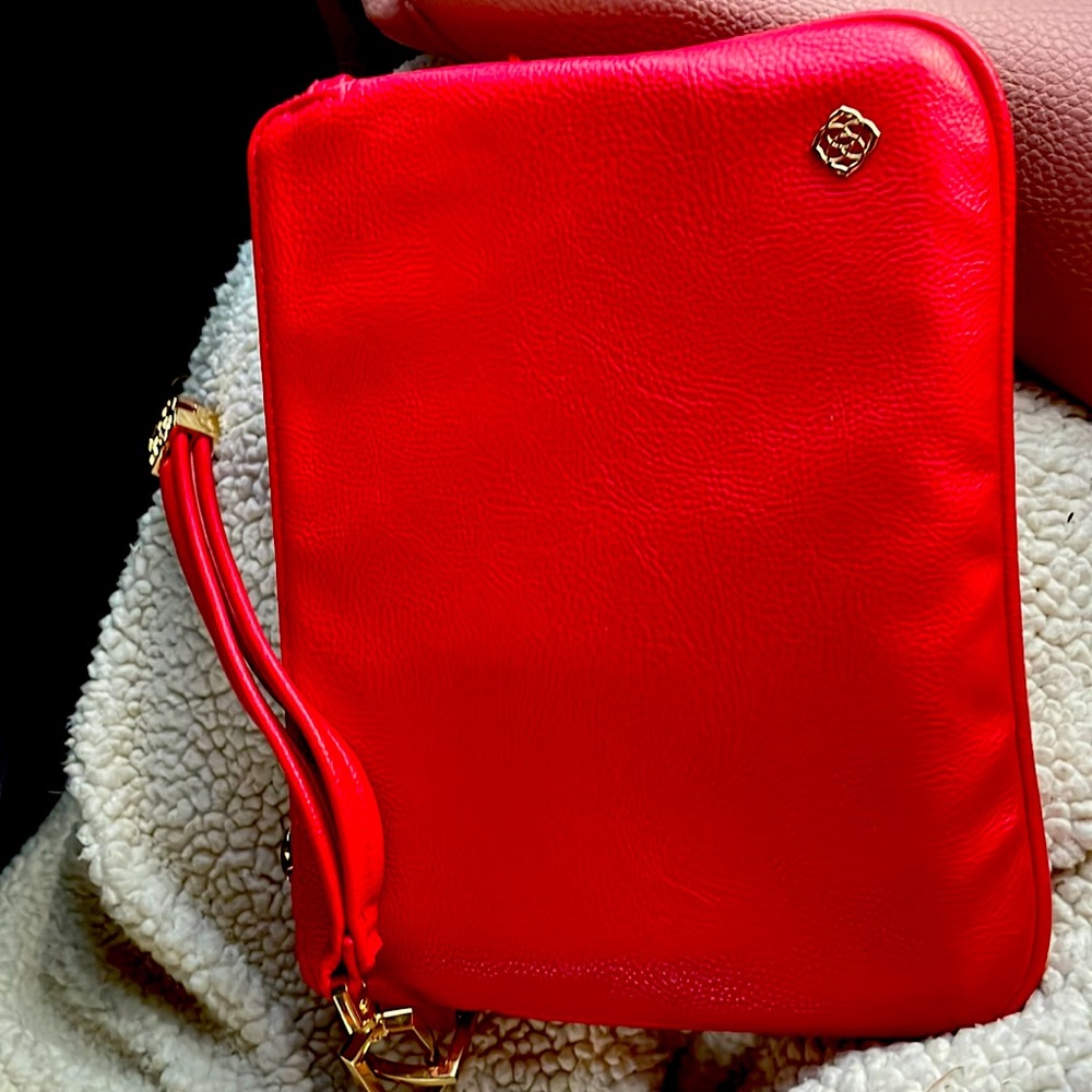 A red makeup bag it is good with traveling and it is dark red